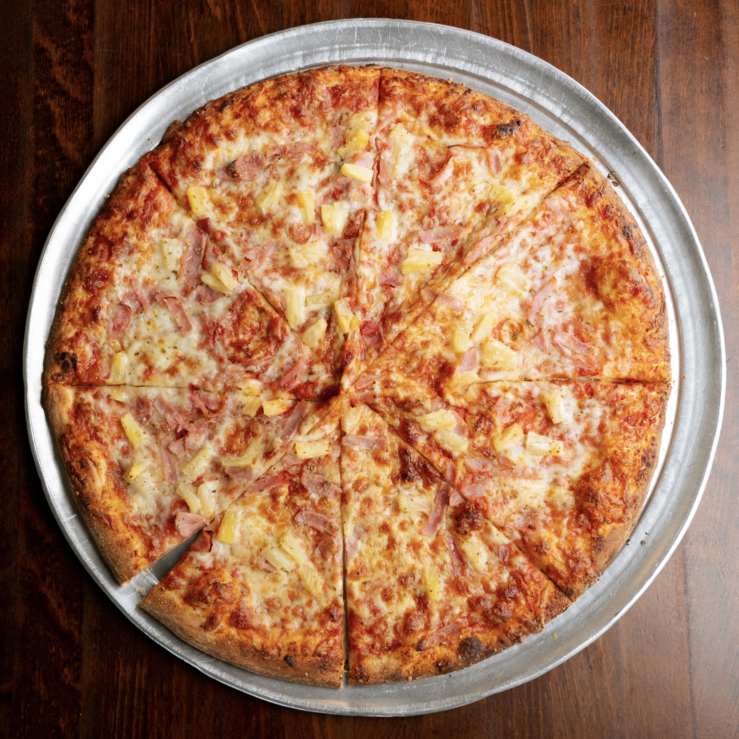 Showcasing Hawaiian pizza slices in Mount Pleasant